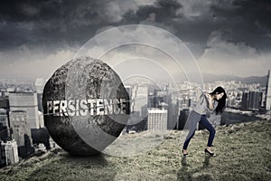 Female entrepreneur with persistence word on the hill