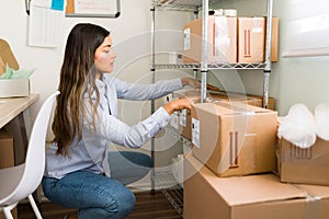 Female entrepreneur preparing to ship packages