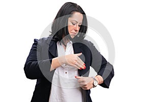 Female entrepreneur preparing for work arranging chest pocket