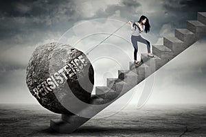 Female entrepreneur pulling persistence word on stair photo