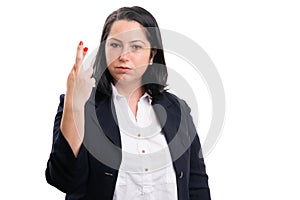 Female entrepreneur serious expression holding fingers crossed