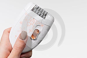 Female epilator on a white background close-up