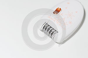 Female epilator on a white background close-up