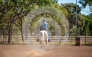 Cowgirl Competing In Barrel Racing Competition At Country Rodeo