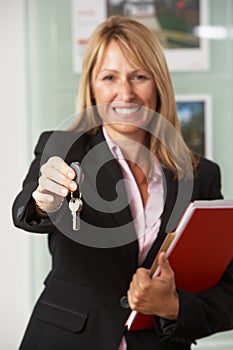 Female Estate Agent Handing Over Keys