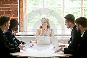 Female executive coaching group of corporate employees during br