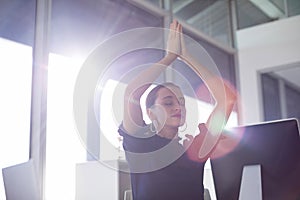 Female executive doing yoga