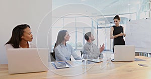 Female executive giving presentation to her colleagues in conference room 4k