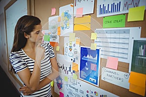 Female executive looking at bulletin board