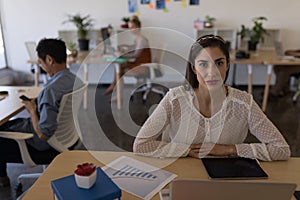 Female executive sitting at desk in office