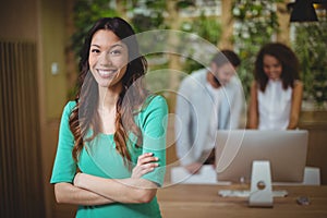 Female executive standing with arms crossed