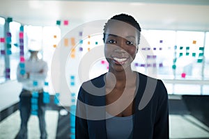 Female executive standing in office