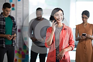 Female executive talking on mobile phone