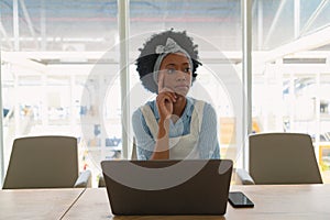 Female executive using laptop in the conference room at office