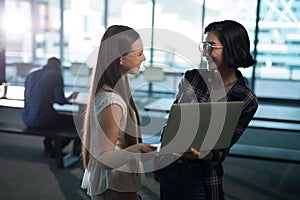 Female executive using laptop in office