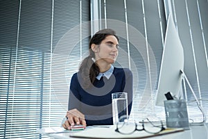 Female executive working on desktop pc at desk