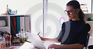 Female executive working at her desk in office 4k