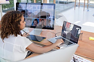 Female executive working over graphic tablet at her desk