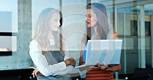 Female executives discussing over laptop 4k