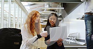 Female executives discussing over laptop 4k