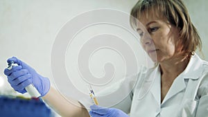 Female expert is working with a plasma test tube