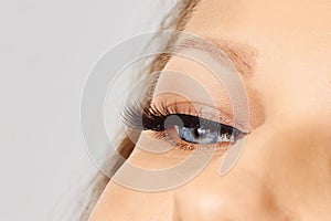 Female eye with extreme long false eyelashes. Eyelash extensions, make-up, cosmetics, beauty