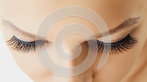 Female eye with extreme long false eyelashes. Eyelash extensions, make-up, cosmetics, beauty and skin care
