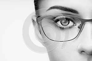 Female eye with long eyelashes in eyeglasses