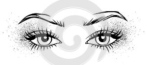 Female eyes with long black eyelashes, glitter silver eyeshadow and brows.