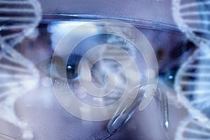 Female eyes in protective glasses while laboratory investigations