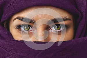 female eyes woman portrait with purple cloth  covered her face
