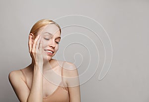 Female face closeup studio portrait. Young attractive woman spa wellness model on white background. Facial treatment, cosmetology