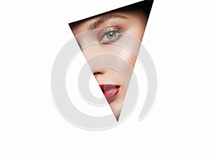 Female face into paper hole. make-up artist concept