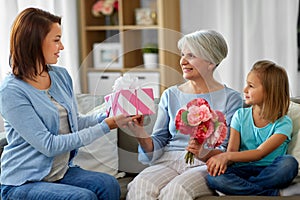 Female family giving present to grandmother