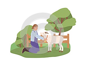 Female farmer with goat on yard. Happy woman in uniform and domestic animal on farm in summer. Rural lifestyle. Stock