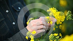 Female Farmer in Oilseed Rapeseed Cultivated Agricultural Field Examining and Controlling The Growth of Plants