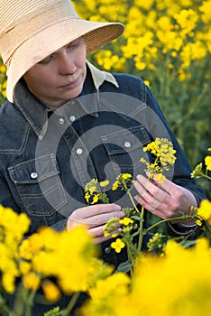 Female Farmer in Oilseed Rapeseed Cultivated Agricultural Field photo