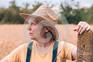 Female farmer posing in ripe barley field just before the harvest