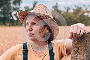 Female farmer posing in ripe barley field just before the harvest