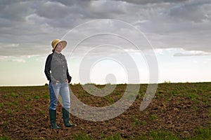 Female Farmer Standing on Fertile Agricultural Farm Land Soil