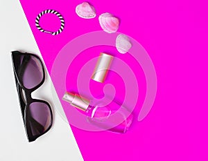 Female fashion accessories on a pink white neon background.