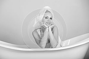 Female fashion, beauty and advertisement concept. relax and hygiene, woman with towel turban in white bathtub