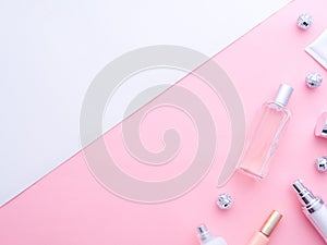 Makeup tools, cosmetics, perfume, creams bottles, Christmas balls on pink white