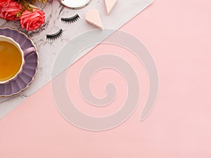 Makeup tools, cosmetics, perfume, creams bottles on pink