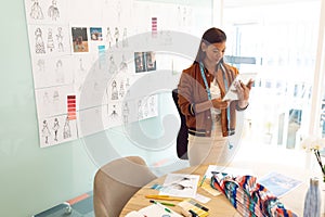 Female fashion designer using digital tablet in a modern office