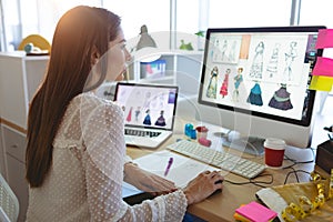 Female fashion designer working on computer at desk