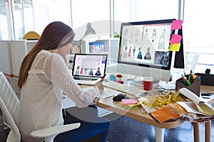 Female fashion designer working at desk in a modern office
