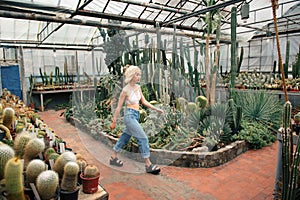 Female fashion model walking among tropical plants