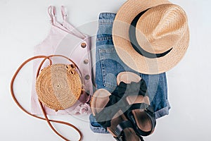 Female fashion outfit - short, top, hat, bag, sandals. Summer holiday clothes. Top view, flat lay