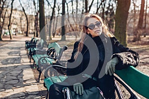 Female fashion. Stylish woman wearing in fur coat, sunglasses and holding handbag. Spring accessories. Portrait